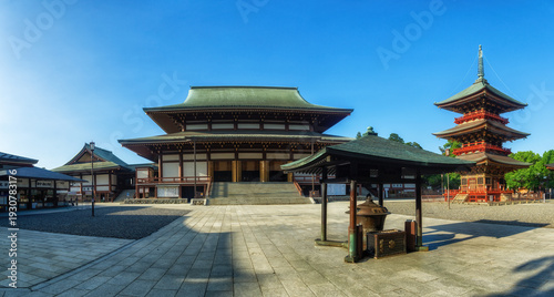 view of Naritasan temple with red pagoda and blue sky in Naritasan Shinshoji temple at Chiba Prefecture.