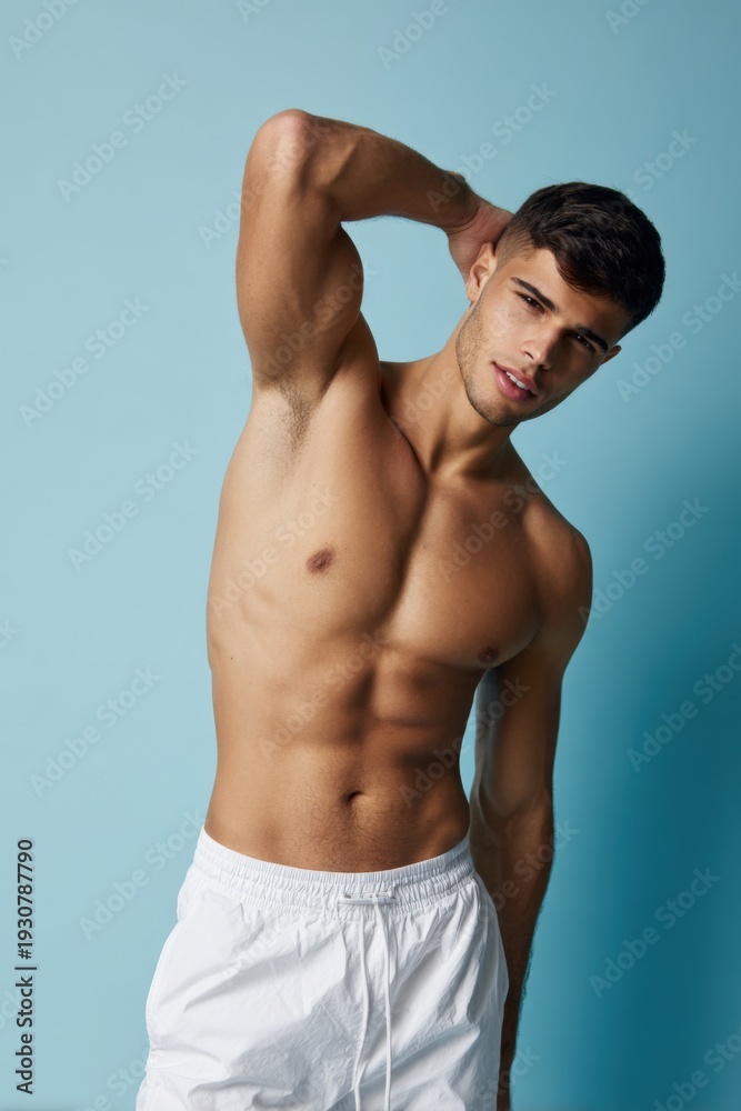Obraz premium Young caucasian male in white shorts against blue background