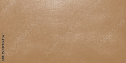 A vintage brown parchment background with an aged, rough paper texture featuring a blank grunge pattern and antique beige cardboard surface for a rustic design backdrop