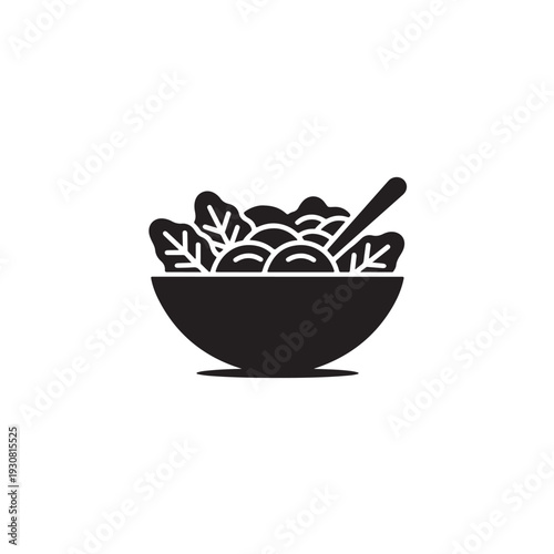 Black silhouette salad bowl with vegetables and spoon