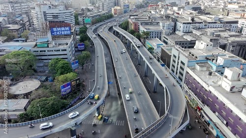 Busy city highway with cars and tuk tuks on elevated road