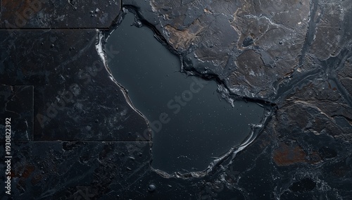 Dark Stone Surface With a Water-Like Formation Outlined by Rough Edges
