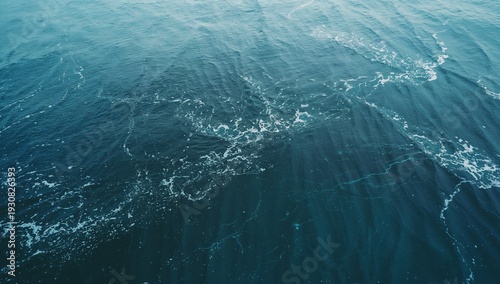 Waves Move in the Ocean During the Day Near the Shoreline in a Clear Blue Sky
