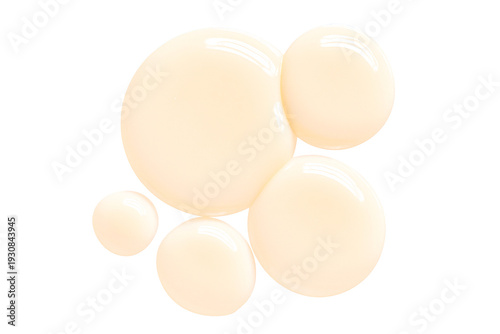 Multiple drops of creamy beige cosmetic lotion