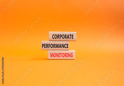 Corporate performance monitoring symbol. Concept word Corporate performance monitoring on wooden blocks. Beautiful orange background. Business and Corporate performance monitoring. Copy space