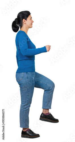 Side view full length portrait of a motivated young woman looking ahead as imaginary climbs a stair to success. Casual lady making a big step ahead isolated on transparent background