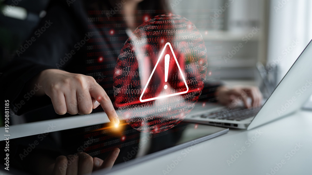 © InfiniteFlow - A focused woman in business attire interacts with a tablet screen showing a digital warning sign, symbolizing security threats in a modern office environment. Gantry