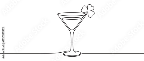 Martini glass with shamrock garnish drawn in elegant continuous line art style, symbolizing luck and celebration for St. Patrick's Day.