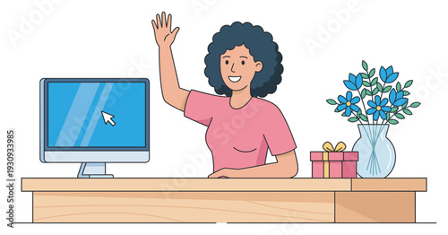 Smiling woman waving hand at desk with computer monitor, gift box, and flowers, engaging in a friendly online interaction.