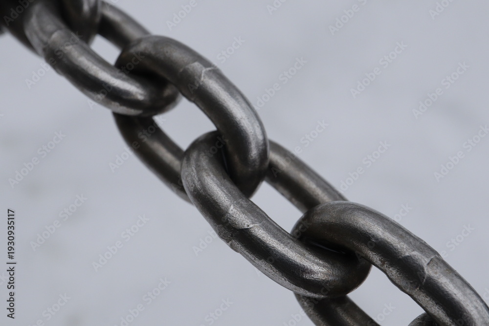 Fototapeta premium Steel chain links close up on light background 