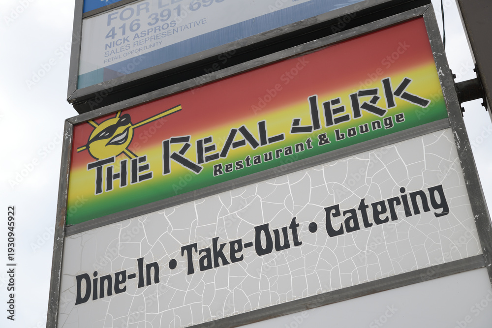 Obraz premium pylon sign for The Real Jerk Restaurant, a Caribbean restaurant, located at 842 Gerrard St E, Toronto