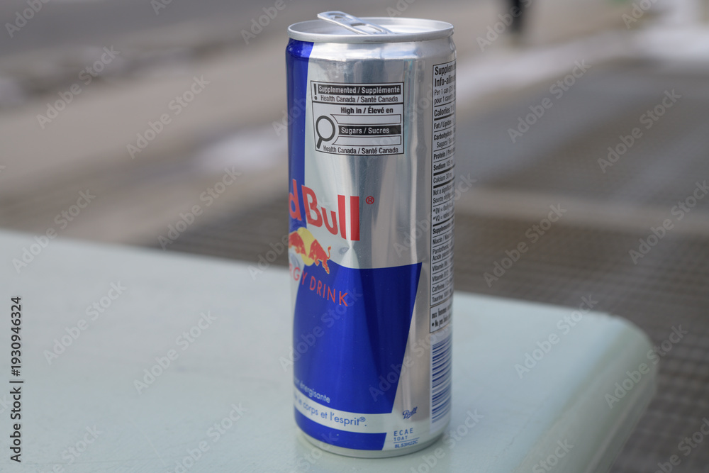 Obraz premium close-up of a discarded can of Redbull (caution box label side) outdoors, Toronto