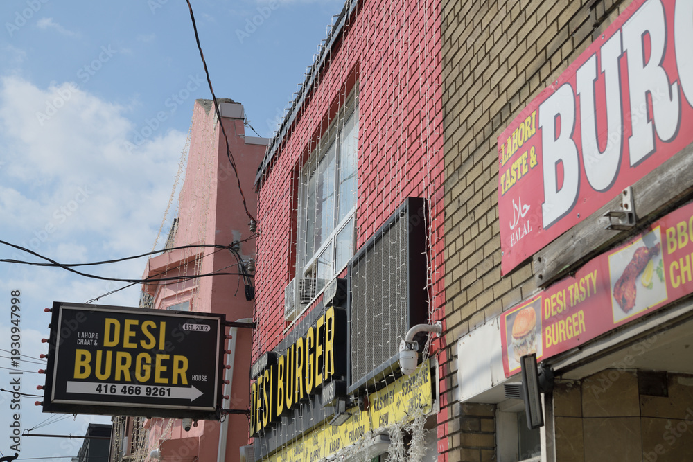 Obraz premium projecting sign outside Desi Burger, a Pakistani restaurant, located at 1342 Gerrard St E, Toronto