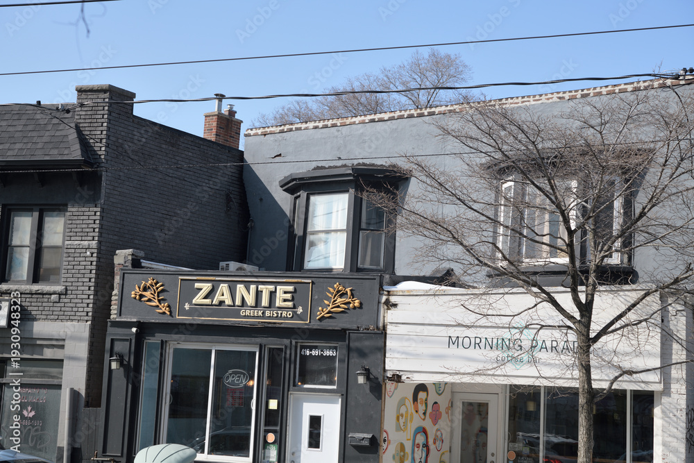 Fototapeta premium buildings and signs for Zante Greek Bistro and Morning Parade Coffee Bar at 1950 and 1954 Gerrard St E (near Woodbine Av), Toronto