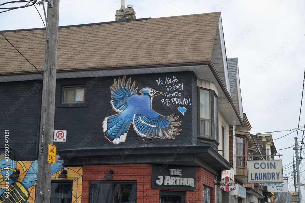 Fototapeta premium exterior building facade mural and sign outside The J Arthur, a restaurant, located at 1044 Gerrard St E, Toronto