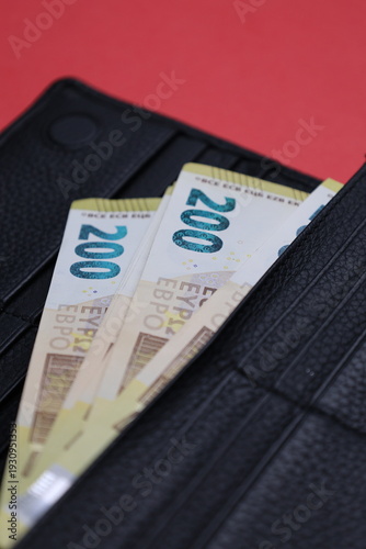 Wallet euro bills. in a wallet on a red background, denomination 200 High quality photo