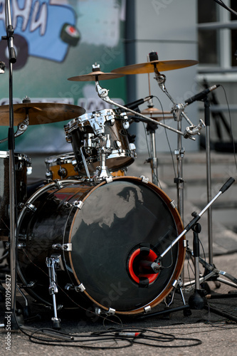 Drum set with bass drum and cymbals on stage during a music performance