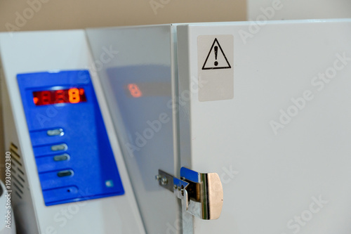 Laboratory freezer with digital display and warning label on door