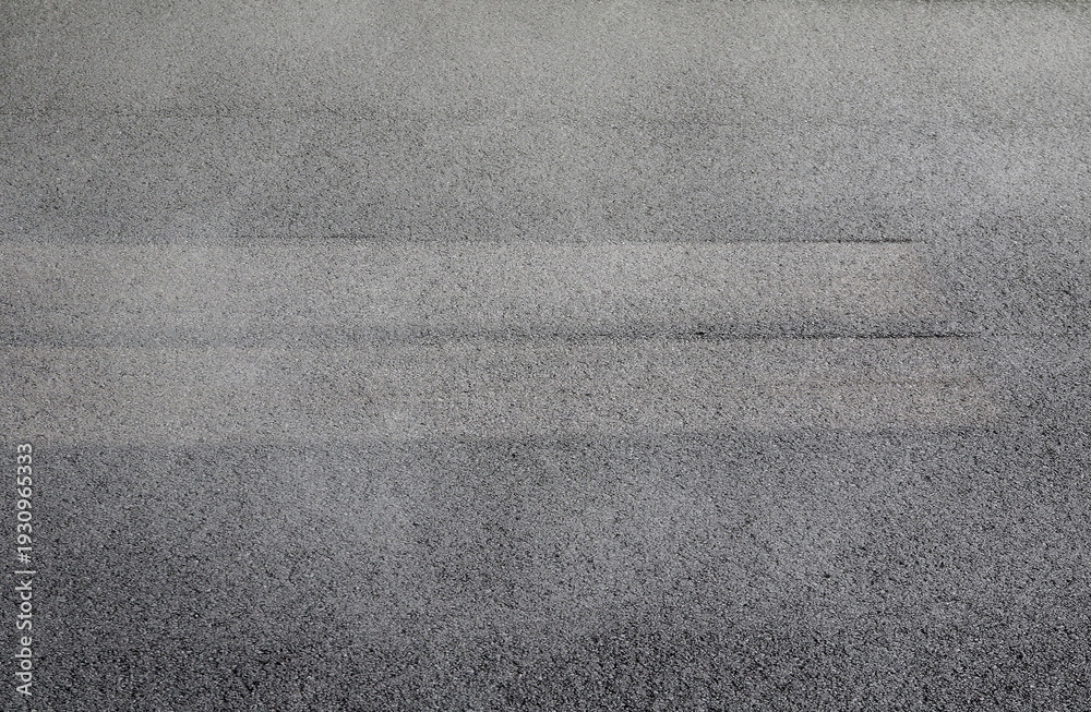 Fototapeta premium New, fresh and hot asphalt road surface with dark texture, close-up horizontal view, side