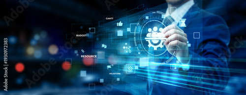 Businessman pointing at project management technology on futuristic digital interface screen, task scheduling dashboard, team collaboration system, workflow optimization concept