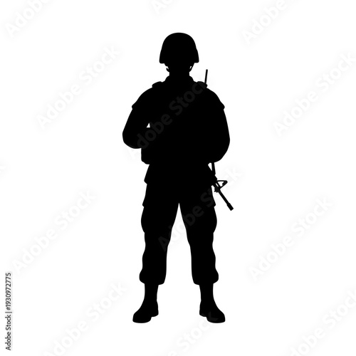 Silhouette of a lone soldier standing with rifle in full combat gear.