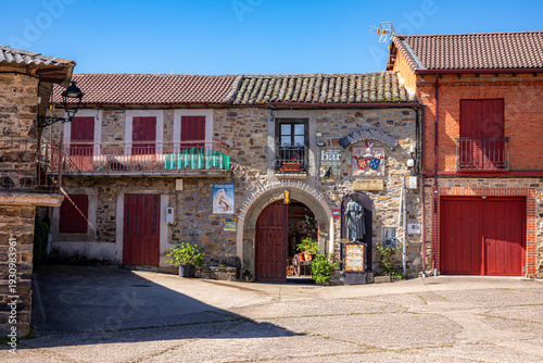 Rustic stone facade of the Albergue El Pilar hostel and bar in the village of Rabanal del Camino, a traditional rest stop for pilgrims on the Camino de Santiago trail in the mountains of Spain.