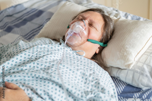 female patient in bed with oxygen mask, Human-centered health support, respiratory support, clinical ventilation interface obstructive sleep apnea treatment, medical breathing equipment in hospital