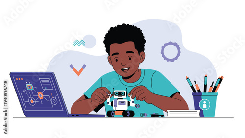 Young African American boy sitting at a desk and happily building a small toy robot with a laptop showing technical diagrams.