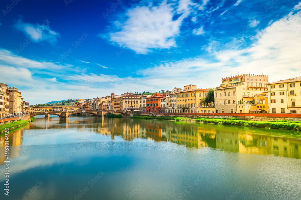 Fototapeta premium famous bridge Ponte Vecchio reflecting in river Arno at summer day, Florence, Italy