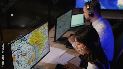 Transport dispatchers coordinating cargo delivery on computer map