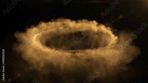 A captivating golden ring of shimmering dust and smoke forms and dissipates elegantly against a deep black background, creating a magical ethereal effect.