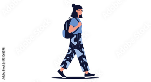 Young girl with glasses and a bun hairstyle walking while wearing a blue t-shirt, patterned trousers, and a black backpack.