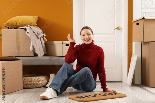Young woman with doormat si...