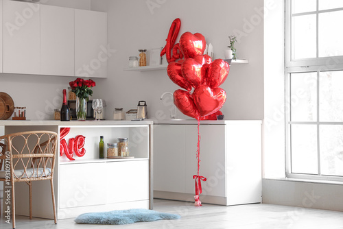Interior of kitchen decorated for Valentine's Day with table, counters and ba...