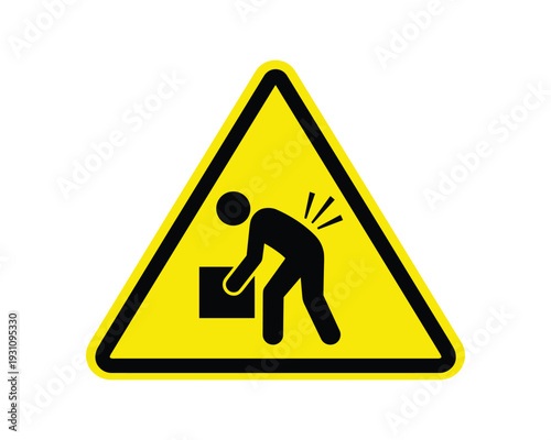 Warning sign of improper lifting causing back injury, yellow triangle with black pictogram, safety caution sign