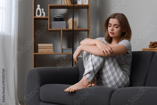 Sad young woman sitting on ...