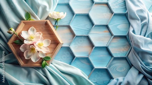 Serene Floral Arrangement on Hexagonal Wooden Background with Flowing Fabric