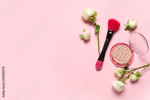 Composition with white rose flowers, highlighter and makeup brush on pink background