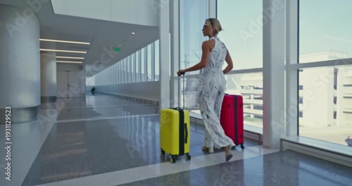 Businesswoman Walking with Suitcase in Modern Airport