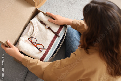 Young woman unpacking cardb...