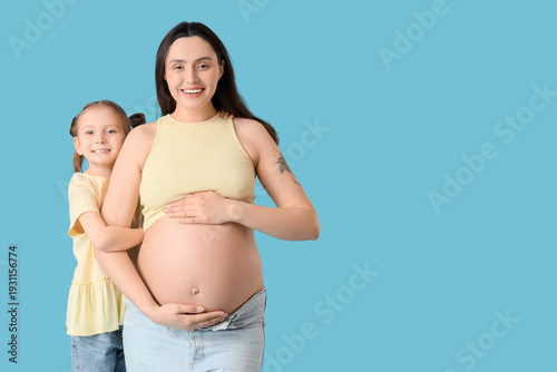 Pregnant woman with daughte...