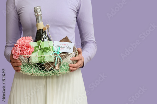 Young woman holding basket ...