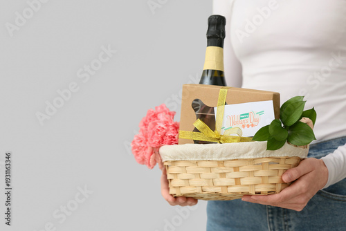 Young woman holding basket ...