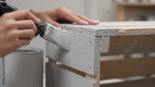 person applying tape to wood surface.