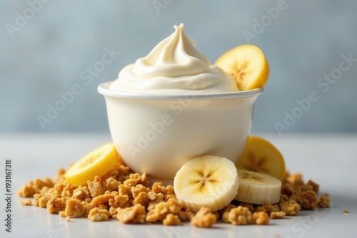 Creamy Yogurt with Banana Slices and Crunchy Granola Topping in a White Bowl
