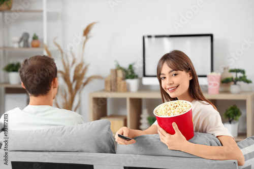 Young woman with popcorn an...