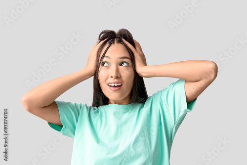 Shocked young Asian woman w...