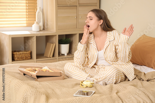 Young woman in pajamas with...
