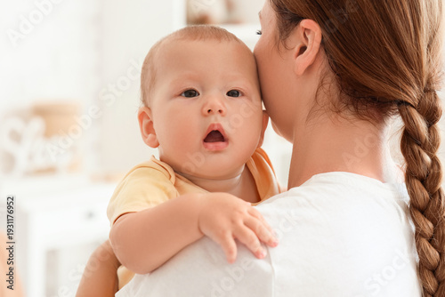 Mother holding her baby in ...