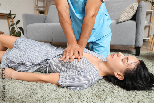 Male doctor doing CPR on un...